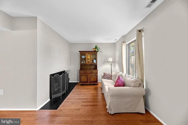 sitting room with wood-type flooring