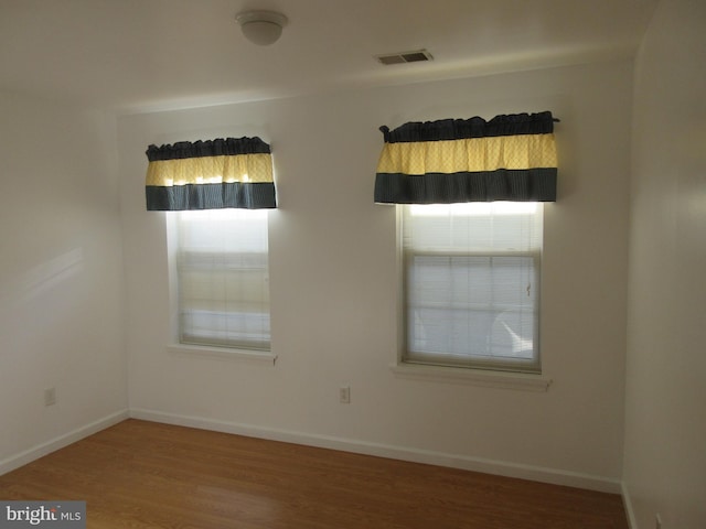 unfurnished room featuring hardwood / wood-style floors