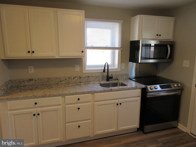 kitchen featuring white cabinets, dark hardwood / wood-style flooring, stainless steel appliances, and sink