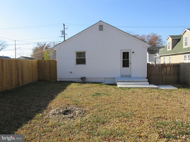 back of property featuring a lawn