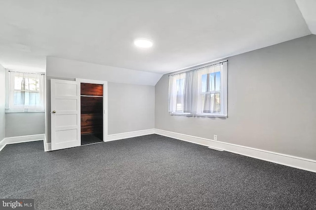 unfurnished bedroom featuring carpet floors and lofted ceiling