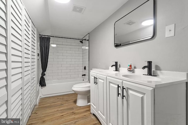 full bathroom featuring shower / bathtub combination with curtain, vanity, toilet, and wood-type flooring