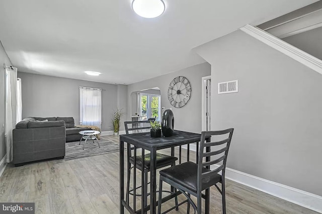 dining space featuring wood-type flooring