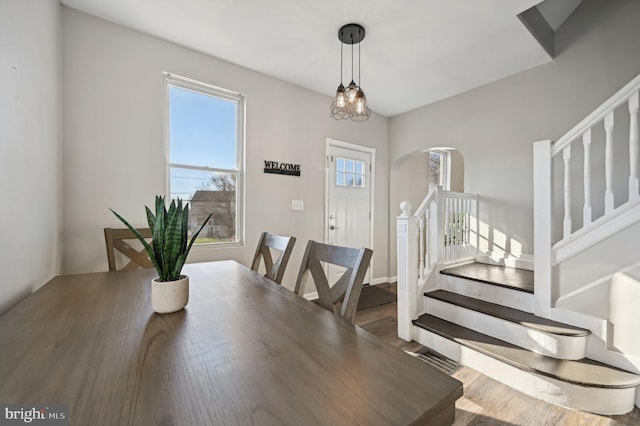 dining space featuring dark wood-type flooring