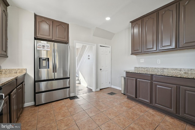 kitchen with dark brown cabinetry and stainless steel fridge