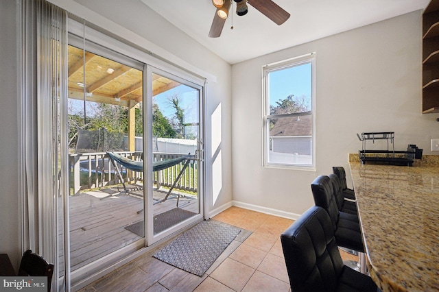 doorway with ceiling fan and light hardwood / wood-style floors