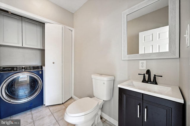 bathroom with tile patterned floors, vanity, toilet, and washer / dryer