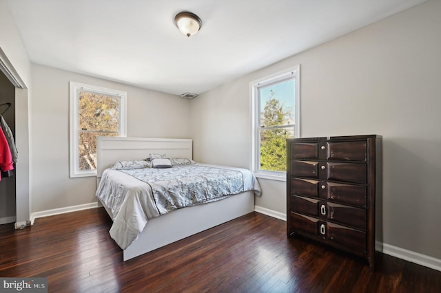 bedroom with dark wood-type flooring