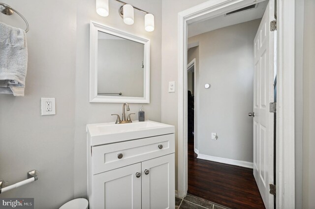 bathroom with hardwood / wood-style flooring and vanity