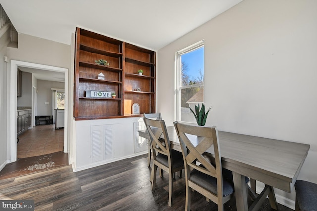 dining space featuring dark hardwood / wood-style flooring