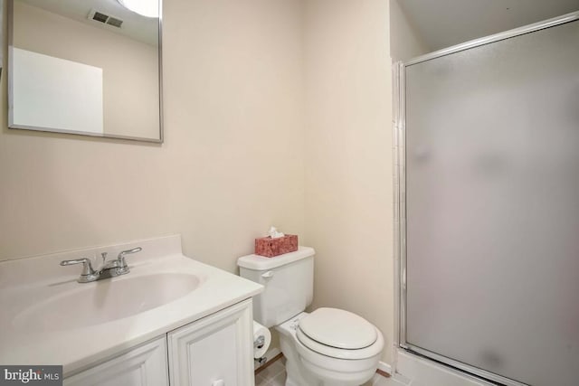 bathroom with vanity, toilet, and an enclosed shower