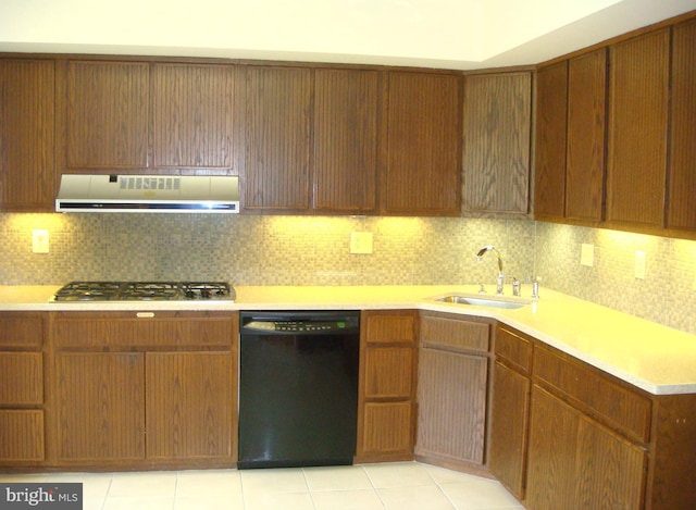 kitchen featuring backsplash, stainless steel gas cooktop, sink, black dishwasher, and range hood