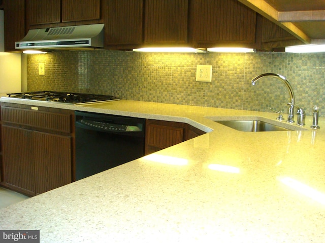 kitchen with stainless steel gas stovetop, exhaust hood, sink, decorative backsplash, and black dishwasher