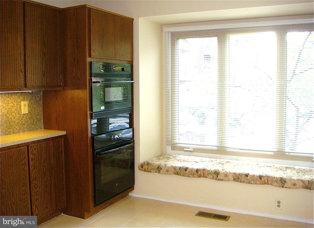 kitchen with decorative backsplash and light tile patterned floors