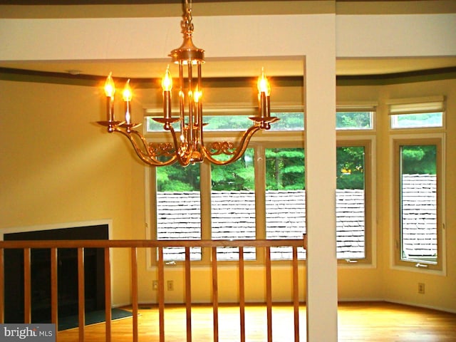 interior space featuring wood-type flooring and a notable chandelier