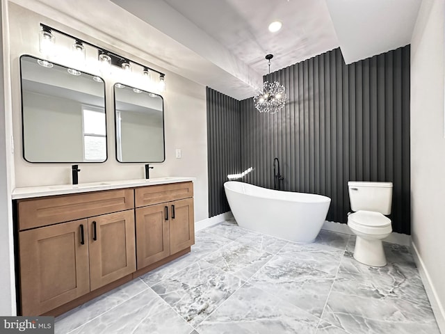 bathroom featuring a notable chandelier, toilet, a bath, and vanity