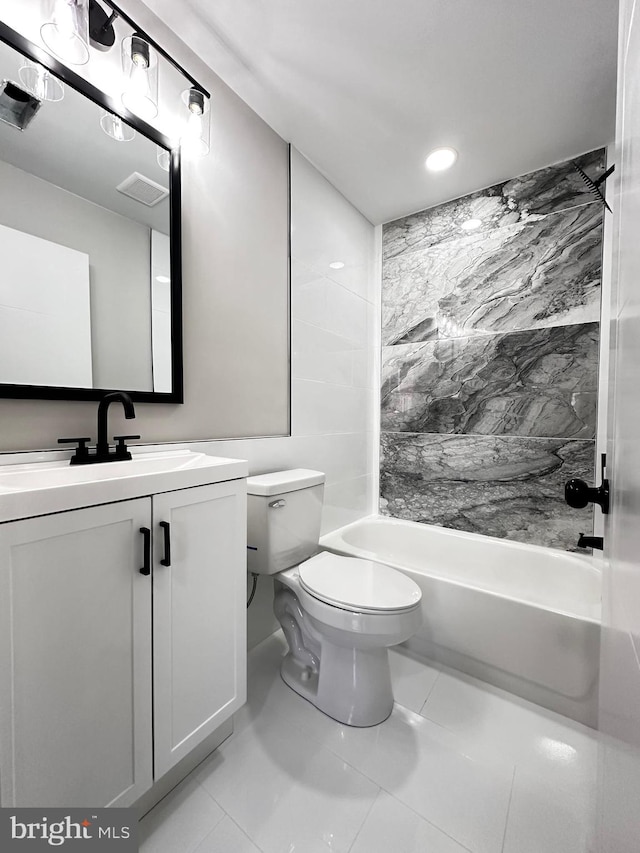 full bathroom with tile patterned flooring, vanity, toilet, and tiled shower / bath combo