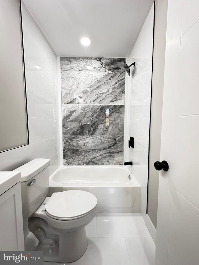 full bathroom featuring tiled shower / bath combo, tile patterned floors, toilet, vanity, and tile walls