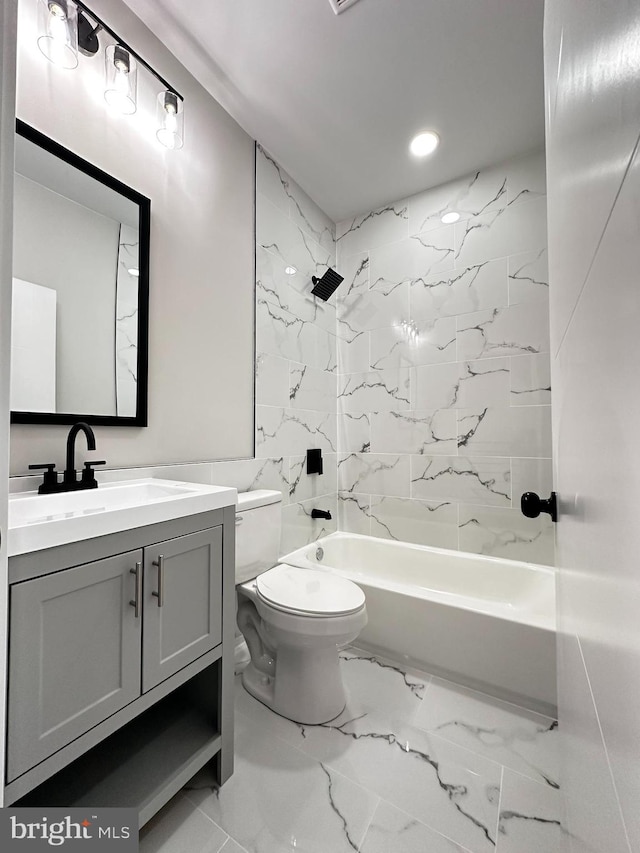 full bathroom with tiled shower / bath combo, toilet, and vanity