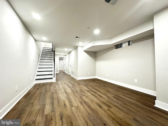 basement with dark hardwood / wood-style flooring