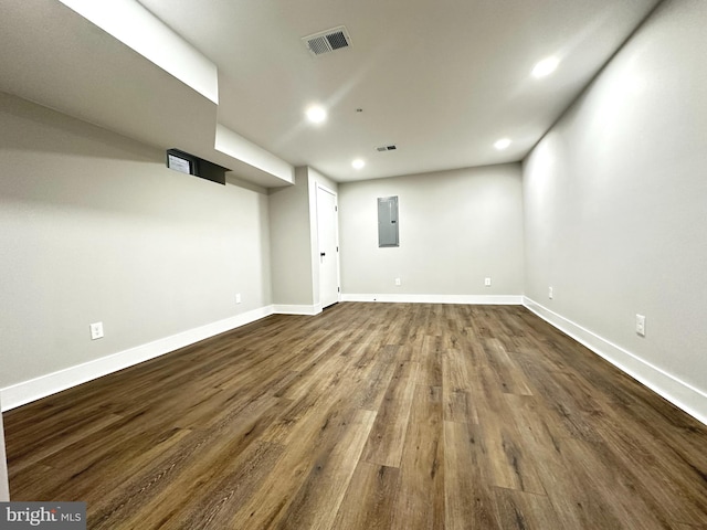 basement with hardwood / wood-style floors and electric panel