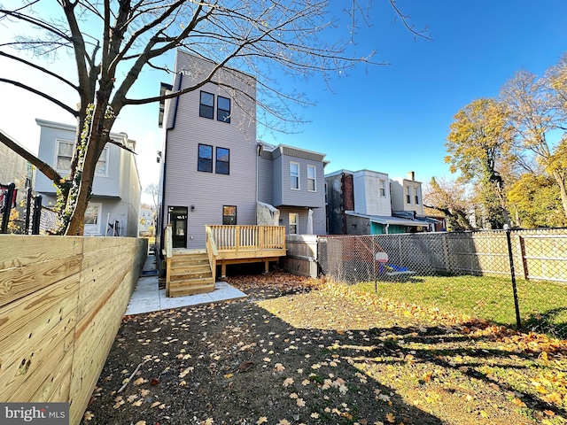 back of house featuring a wooden deck