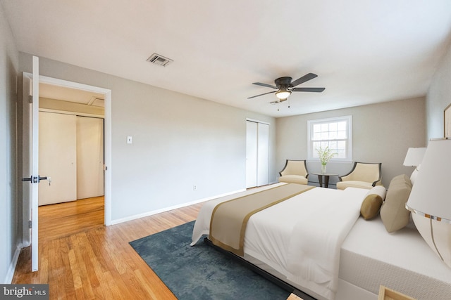 bedroom featuring ceiling fan, a closet, and light hardwood / wood-style flooring