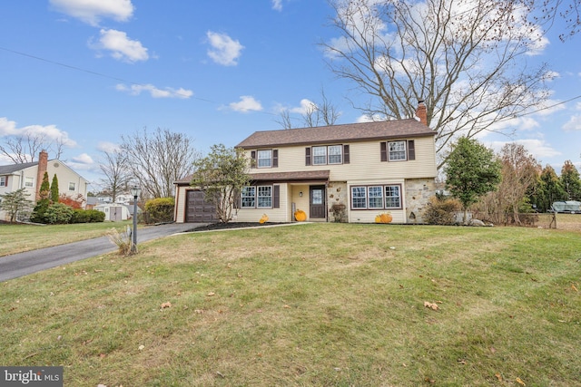 front of property featuring a front yard and a garage