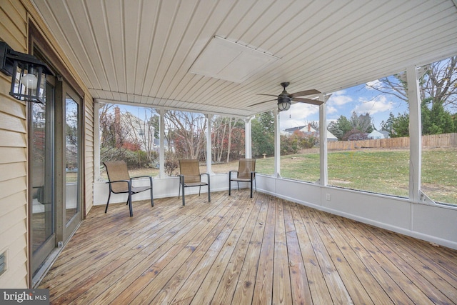 unfurnished sunroom with ceiling fan and a healthy amount of sunlight