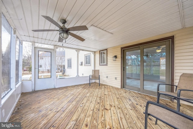 unfurnished sunroom with ceiling fan and wooden ceiling