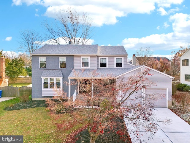 front of property with a garage and a front lawn