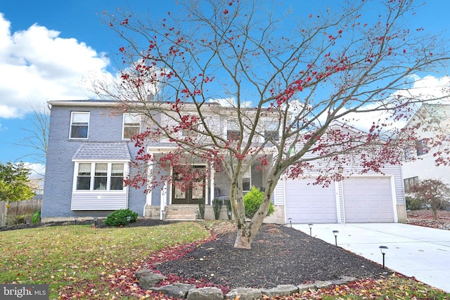 view of front facade featuring a front lawn, a garage, and french doors