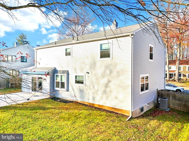 back of house with a yard, central AC unit, and a patio area