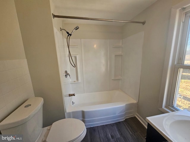 full bathroom with hardwood / wood-style flooring, vanity, shower / bath combination, and toilet