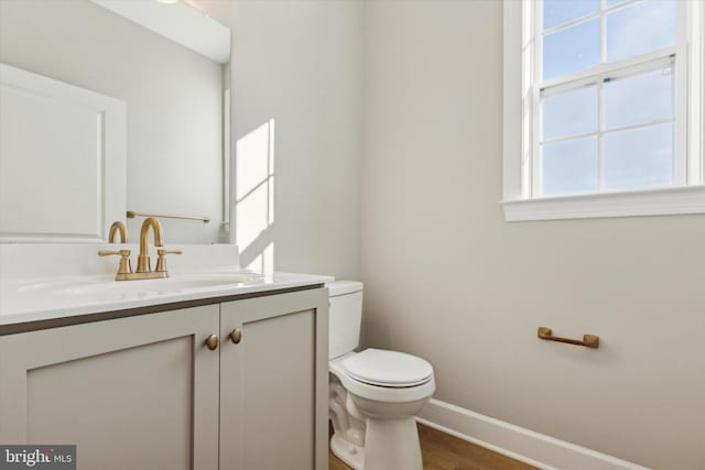 bathroom featuring hardwood / wood-style flooring, vanity, and toilet