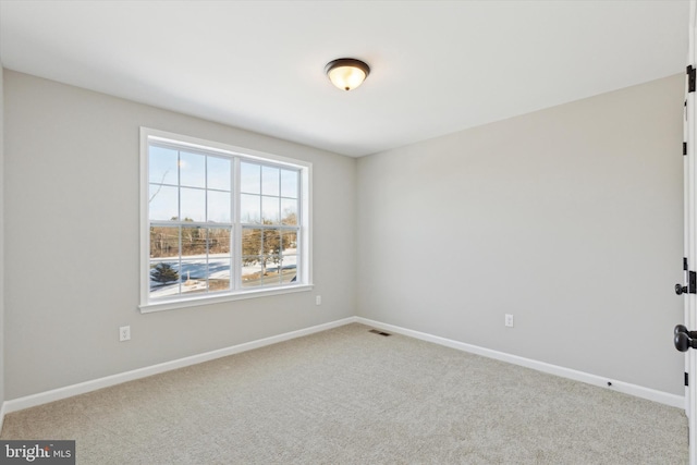 unfurnished room with light colored carpet