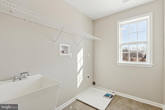 washroom with hookup for an electric dryer, washer hookup, and sink