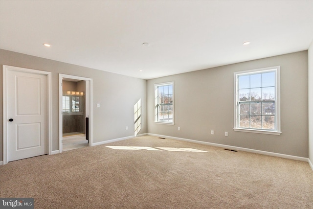 spare room with light colored carpet