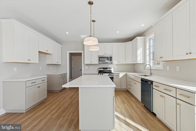 kitchen with hanging light fixtures, white cabinetry, a center island, and stainless steel appliances