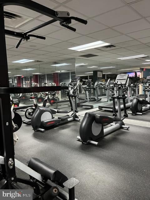 workout area with visible vents and a paneled ceiling