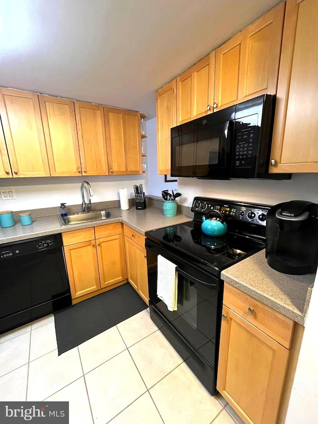 kitchen with black appliances, light tile patterned floors, light countertops, and a sink