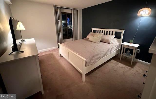 bedroom featuring carpet and baseboards