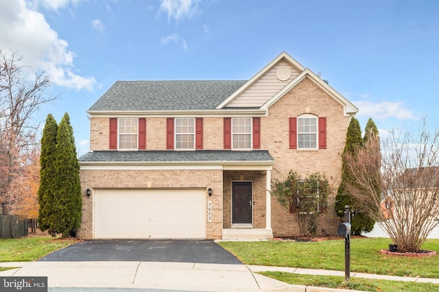 front facade featuring a garage and a front yard