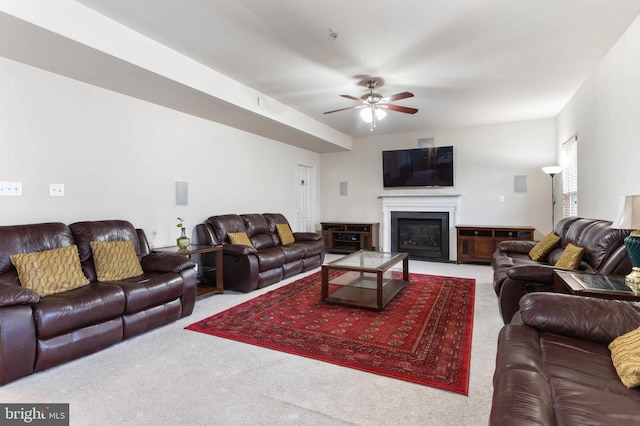 carpeted living room with ceiling fan