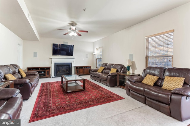 carpeted living room with ceiling fan