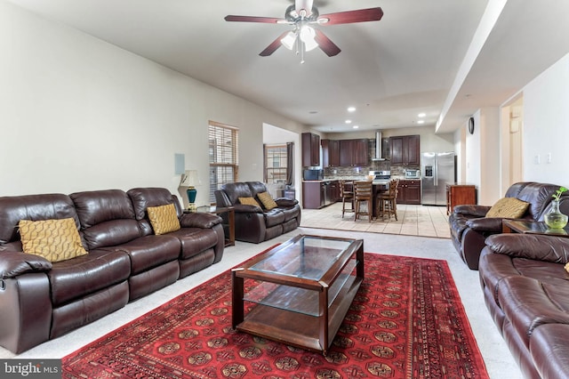 carpeted living room featuring ceiling fan