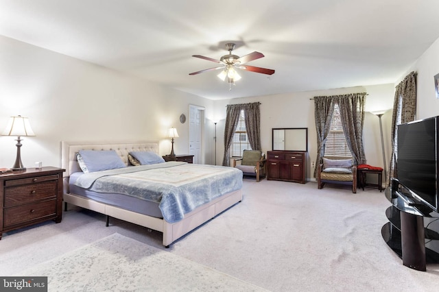 bedroom with ceiling fan and light colored carpet