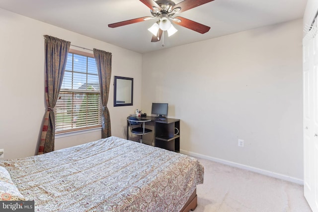 carpeted bedroom with multiple windows and ceiling fan