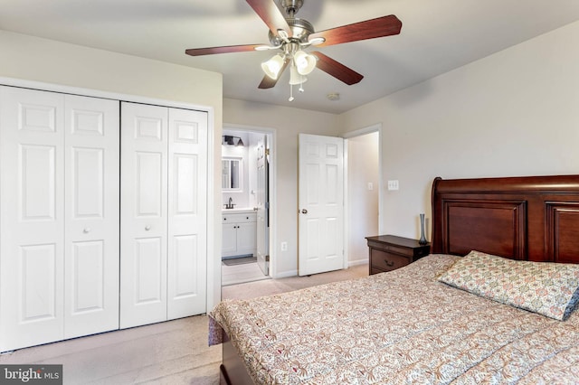 bedroom with ceiling fan, a closet, and ensuite bath