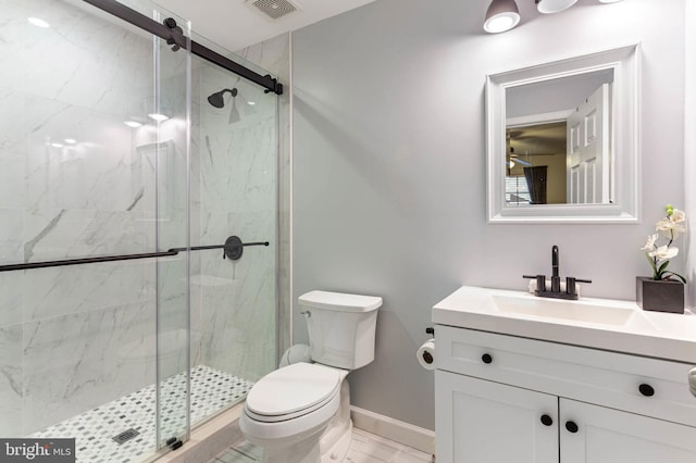 bathroom featuring vanity, toilet, and an enclosed shower